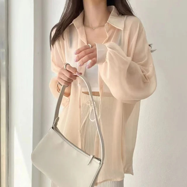 Sheer beige long sleeve button shirt over white crop top with bag lightweight sun protection shirt for layering