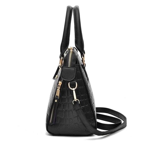 Black crocodile leather handbag side view with double top handles detachable shoulder strap and gold hardware zipper