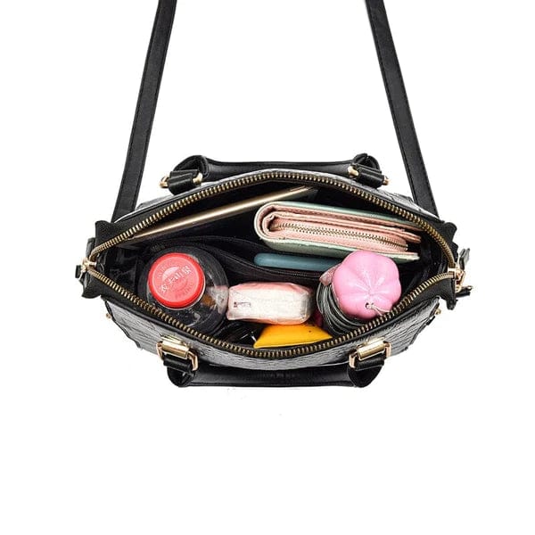 Black crocodile leather handbag open top view showing wallet makeup bottle and organized zippered compartments