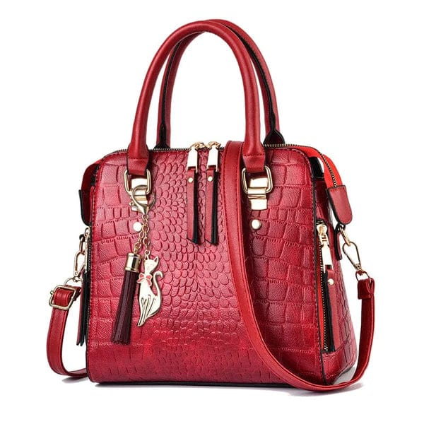 Red crocodile leather handbag with gold hardware, tassel and cat charm, top handles and detachable shoulder strap