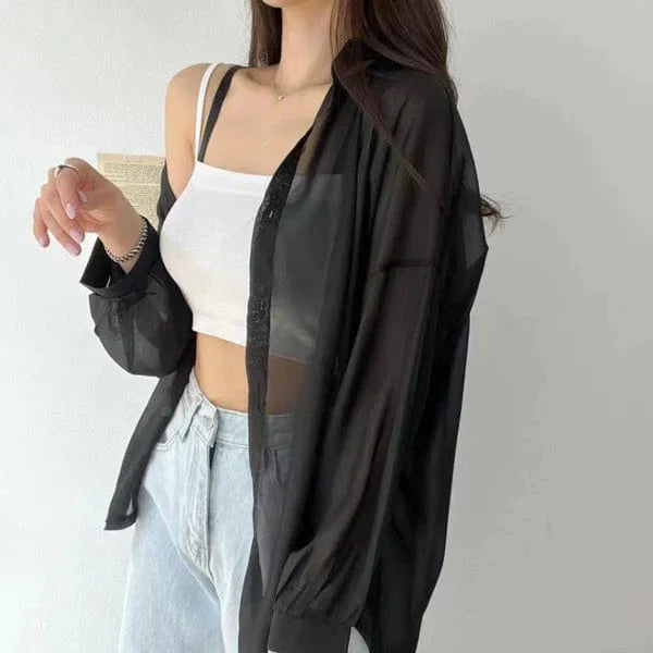Sheer black oversized lightweight sun protection shirt worn open over white crop tank and light jeans