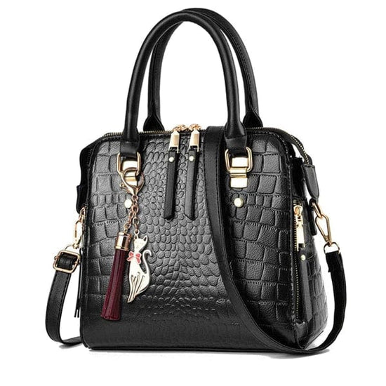 Black crocodile leather handbag with gold hardware, top handles, detachable shoulder strap and tassel charm
