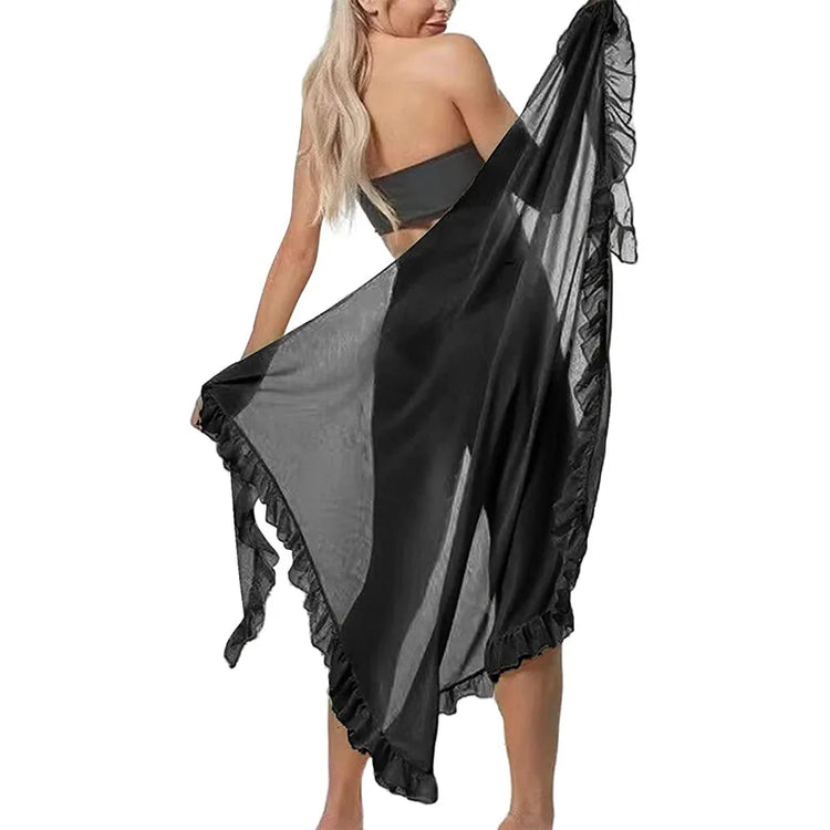 Back view of model holding black sheer ruffle summer beach wrap skirt tied at waist for coverage